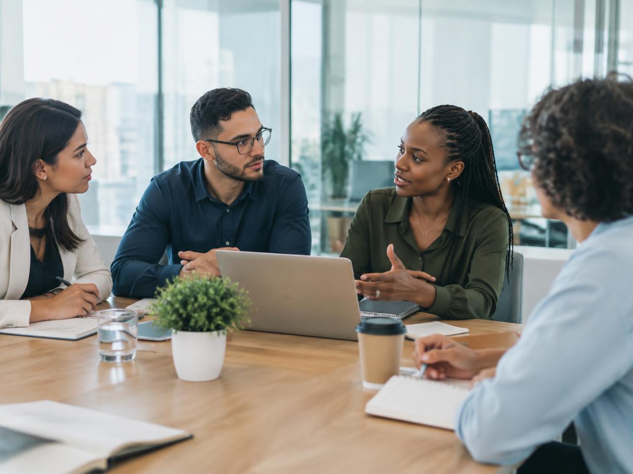 Hiring team discussing recruitment needs around a table
